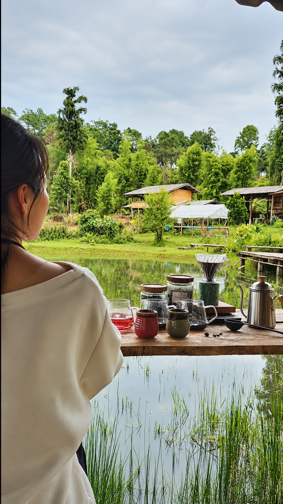 Specialty coffee brewing overlooking a rural coffee farm landscape in Chiang Mai Thailand