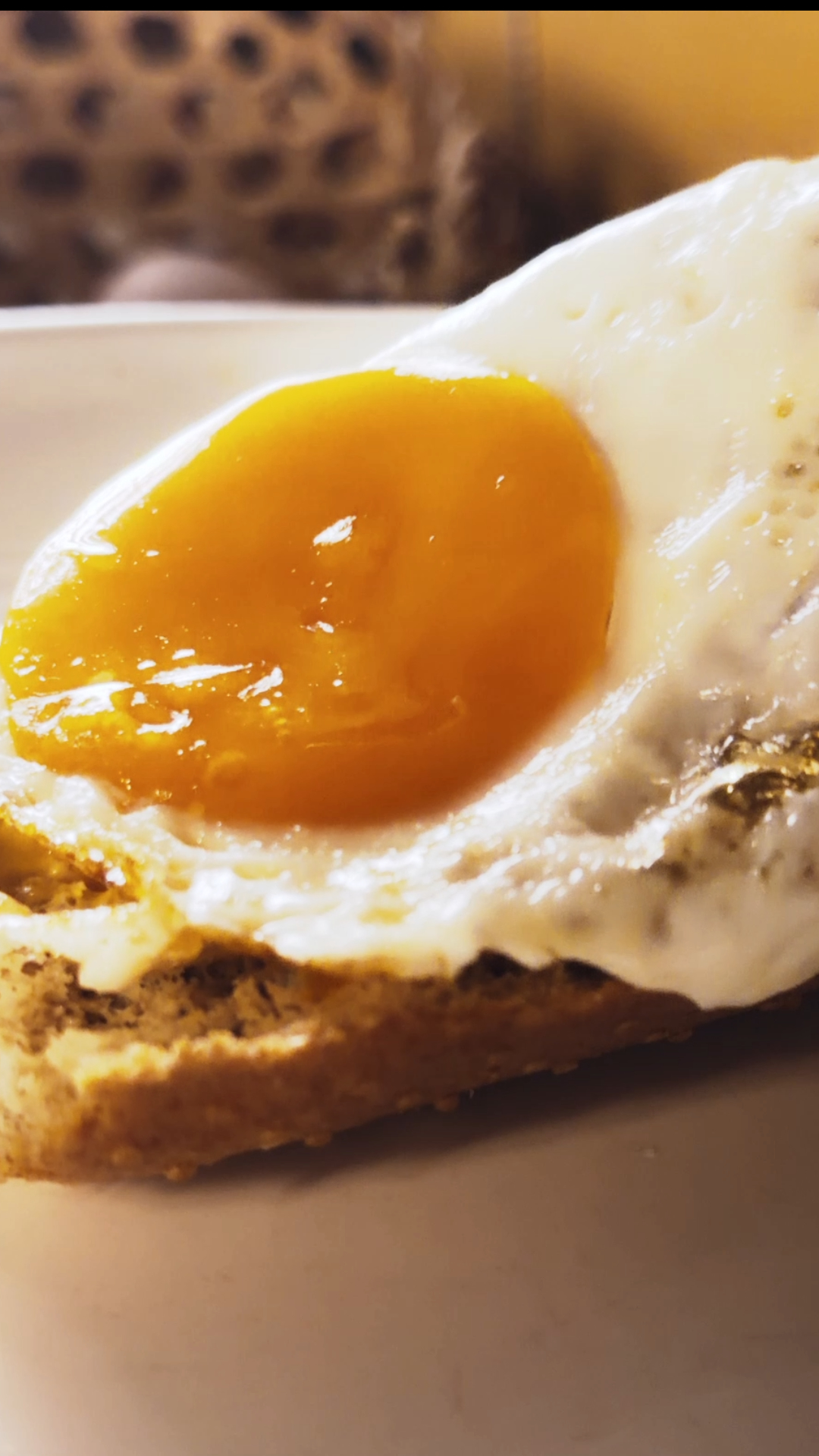 Runny egg yolk and toasted bread captured for a cinematic food commercial