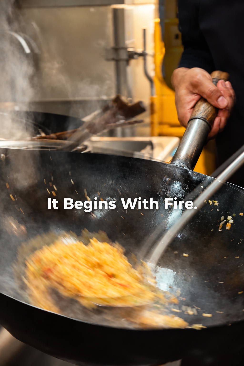 Wok cooking action and steam inside MUSE Peranakan Bistro kitchen in Melaka