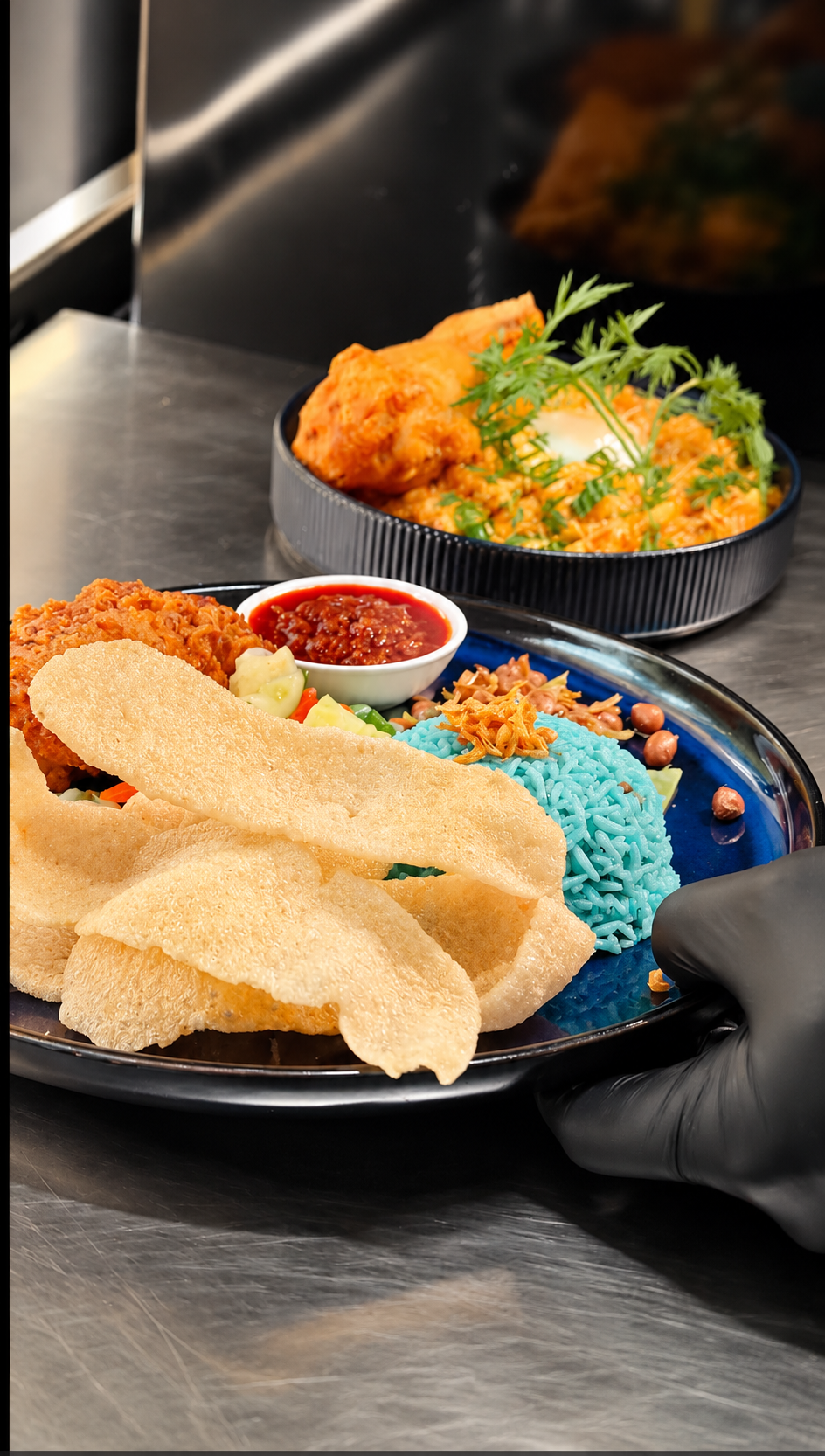Close-up food plating with fried chicken blue rice and sambal at MUSE Melaka